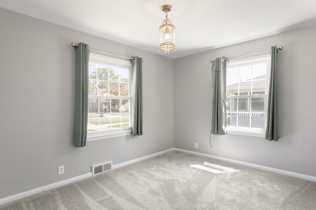 1200 Orchard Ave, Saint Joseph, MI 49085 - carpeted empty room with baseboards and a chandelier