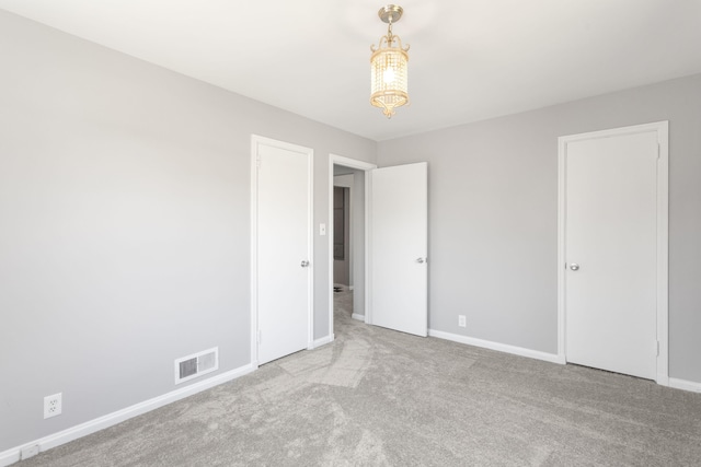1200 Orchard Ave, Saint Joseph, MI 49085 - unfurnished bedroom featuring carpet and a chandelier
