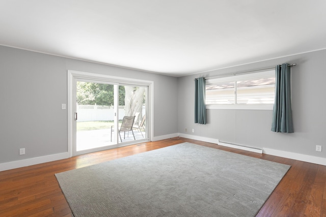 1200 Orchard Ave, Saint Joseph, MI 49085 - spare room featuring a baseboard heating unit and wood finished floors