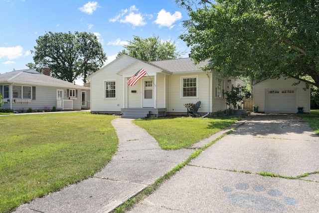 1200 Orchard Ave, Saint Joseph, MI 49085 - bungalow with an outbuilding, a detached garage, a front lawn, and asphalt driveway