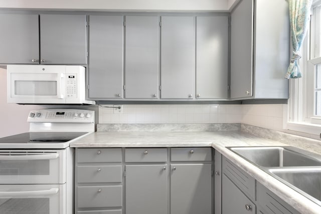 1200 Orchard Ave, Saint Joseph, MI 49085 - kitchen with white appliances, gray cabinetry, and decorative backsplash