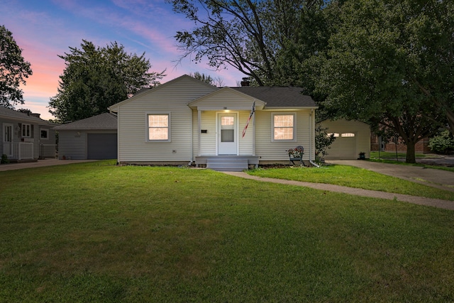 1200 Orchard Ave, Saint Joseph, MI 49085 - view of front of house with concrete driveway, a yard, and a garage