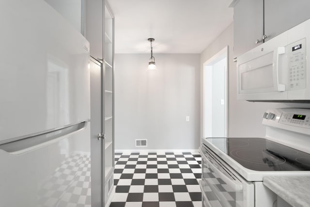 1200 Orchard Ave, Saint Joseph, MI 49085 - kitchen featuring white appliances, dark flooring, light countertops, and hanging light fixtures
