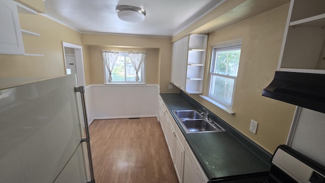19969 Poinciana, Redford, MI 48240 - kitchen with stove, white cabinets, light wood-style floors, plenty of natural light, and ornamental molding
