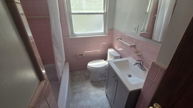 19969 Poinciana, Redford, MI 48240 - full bathroom featuring vanity, tile walls, shower / tub combo, and wainscoting