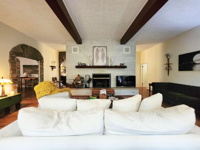 241 Dale St, Grayling, MI 49738 - living room with a stone fireplace, wood finished floors, and beamed ceiling
