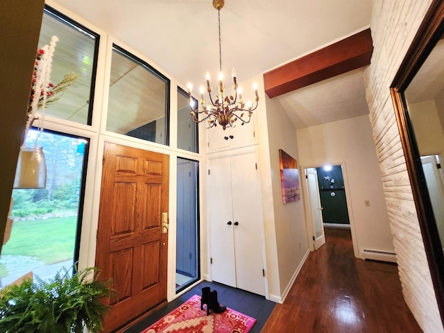 241 Dale St, Grayling, MI 49738 - entrance foyer with baseboard heating, a chandelier, wood finished floors, and high vaulted ceiling