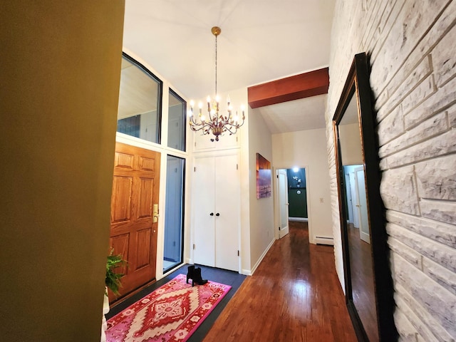 241 Dale St, Grayling, MI 49738 - foyer entrance featuring a chandelier, wood finished floors, and baseboard heating