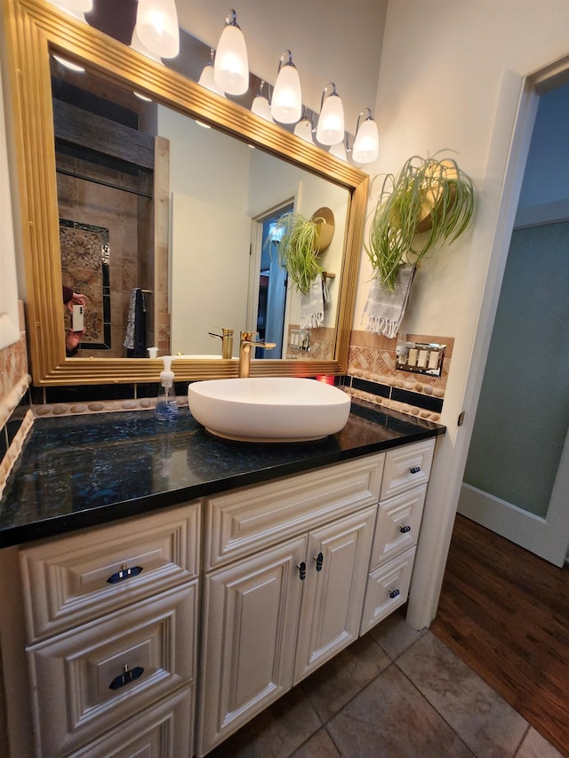241 Dale St, Grayling, MI 49738 - full bath with vanity, tasteful backsplash, and tile patterned floors