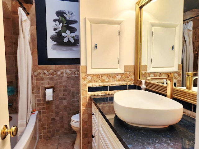 241 Dale St, Grayling, MI 49738 - bathroom featuring tile walls, tile patterned floors, a wainscoted wall, vanity, and shower / bath combo with shower curtain