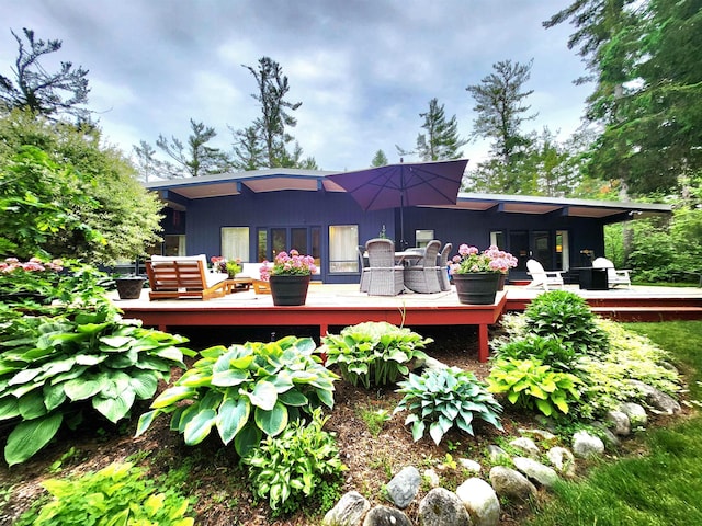 241 Dale St, Grayling, MI 49738 - rear view of house featuring a deck, outdoor dining space, and an outdoor living space