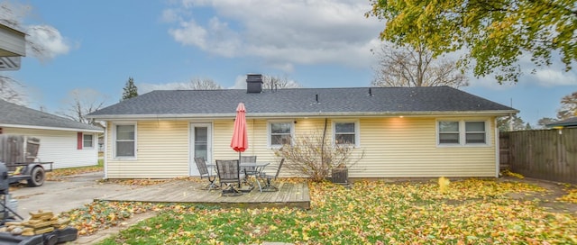 19 Vogt St, Coldwater, MI 49036 - back of house with a chimney, a wooden deck, and outdoor dining area