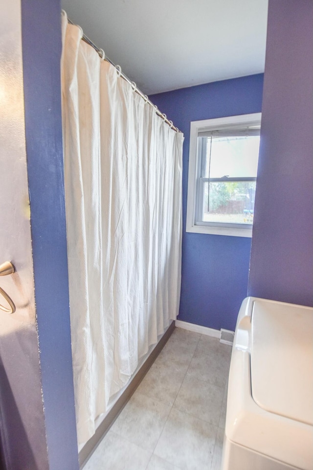 19 Vogt St, Coldwater, MI 49036 - bathroom featuring washer / dryer and a shower with curtain