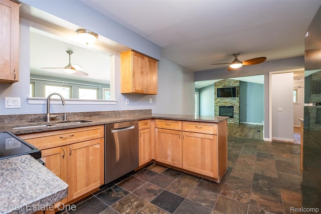4079 Cumberland Ct, Commerce Twp, MI 48390 - kitchen featuring a ceiling fan, stainless steel dishwasher, a peninsula, a stone fireplace, and dark stone finish floors