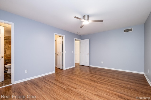 4079 Cumberland Ct, Commerce Twp, MI 48390 - unfurnished bedroom with wood finished floors, connected bathroom, and ceiling fan