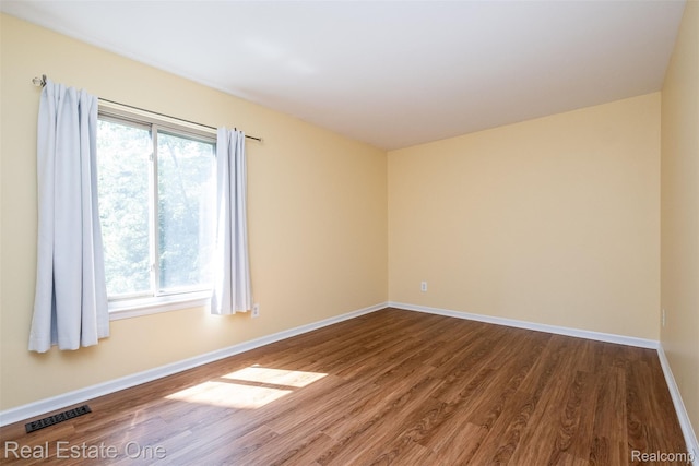 4079 Cumberland Ct, Commerce Twp, MI 48390 - unfurnished room with dark wood-style flooring