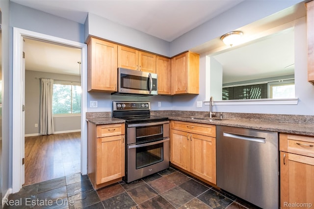 4079 Cumberland Ct, Commerce Twp, MI 48390 - kitchen featuring appliances with stainless steel finishes, light brown cabinetry, and dark stone countertops