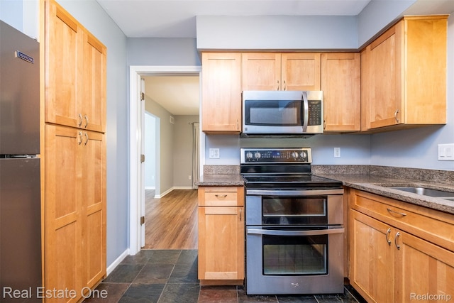 4079 Cumberland Ct, Commerce Twp, MI 48390 - kitchen featuring appliances with stainless steel finishes and dark stone countertops