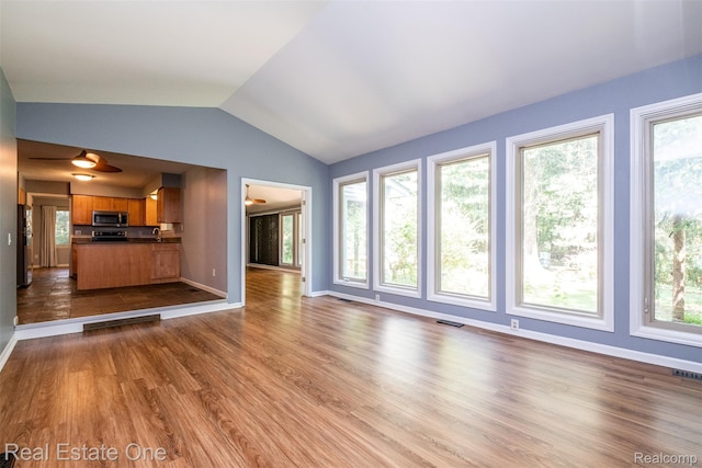 4079 Cumberland Ct, Commerce Twp, MI 48390 - unfurnished living room with vaulted ceiling and wood finished floors