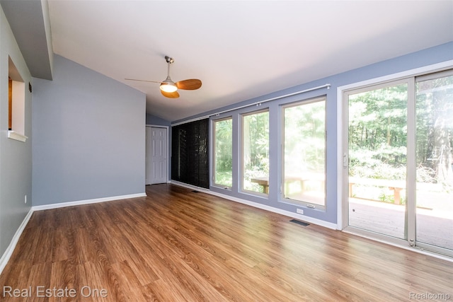 4079 Cumberland Ct, Commerce Twp, MI 48390 - unfurnished room with lofted ceiling, healthy amount of natural light, wood finished floors, and a ceiling fan
