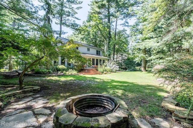 4079 Cumberland Ct, Commerce Twp, MI 48390 - view of green lawn featuring an outdoor fire pit