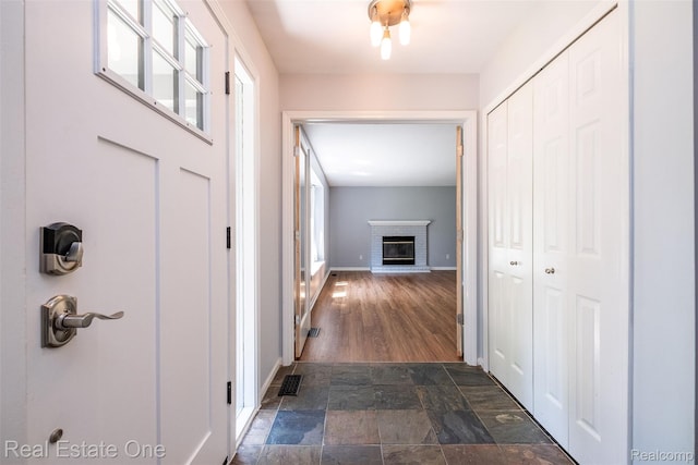 4079 Cumberland Ct, Commerce Twp, MI 48390 - hallway with dark stone finish flooring and baseboards