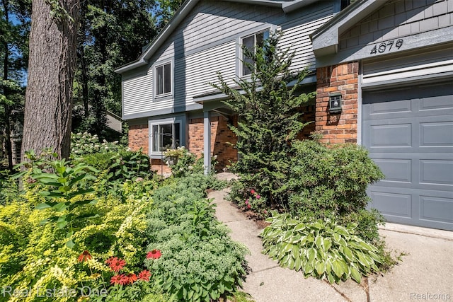 4079 Cumberland Ct, Commerce Twp, MI 48390 - doorway to property with brick siding