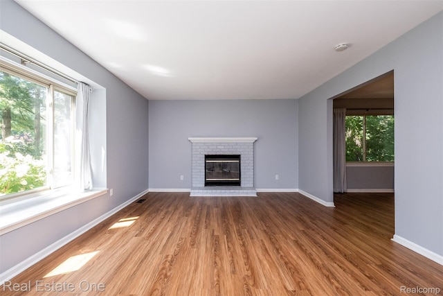 4079 Cumberland Ct, Commerce Twp, MI 48390 - unfurnished living room with wood finished floors and a fireplace