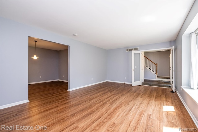 4079 Cumberland Ct, Commerce Twp, MI 48390 - empty room with wood finished floors and stairs