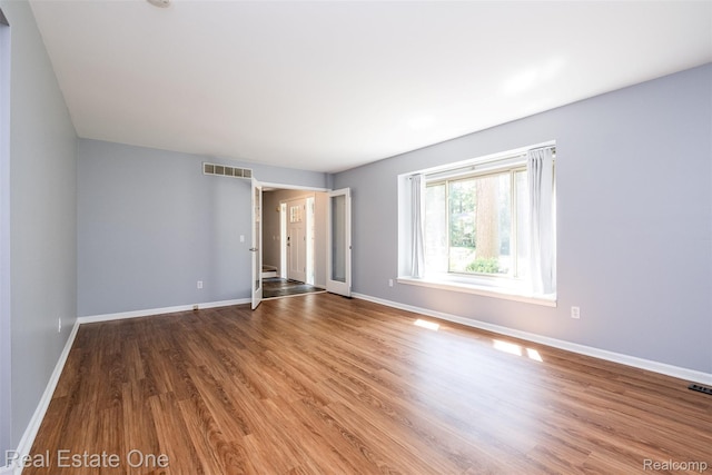4079 Cumberland Ct, Commerce Twp, MI 48390 - empty room with wood finished floors and baseboards