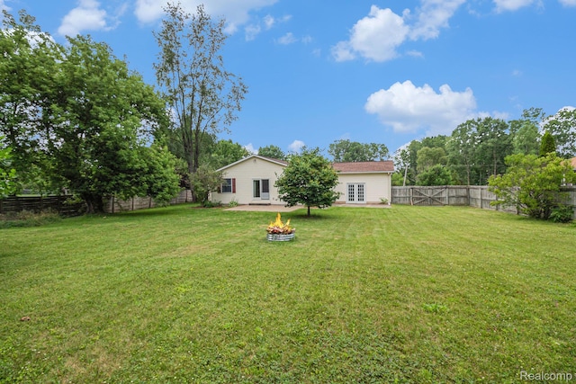 5511 Wakefield Rd, Grand Blanc, MI 48439 - fenced backyard featuring a fire pit and french doors