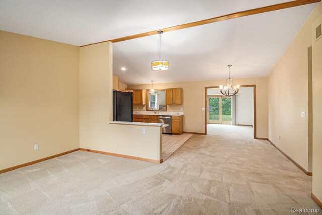 5511 Wakefield Rd, Grand Blanc, MI 48439 - kitchen with black fridge, light colored carpet, dishwasher, light countertops, and a chandelier
