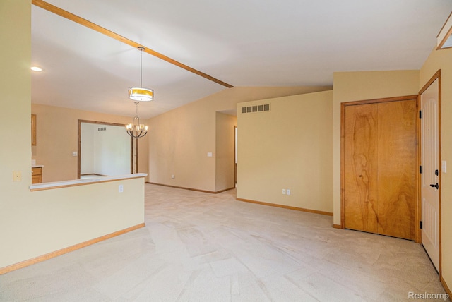 5511 Wakefield Rd, Grand Blanc, MI 48439 - empty room with light carpet, vaulted ceiling, and a chandelier