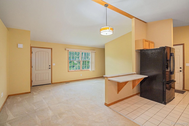 5511 Wakefield Rd, Grand Blanc, MI 48439 - kitchen with freestanding refrigerator, decorative light fixtures, vaulted ceiling, light carpet, and light countertops