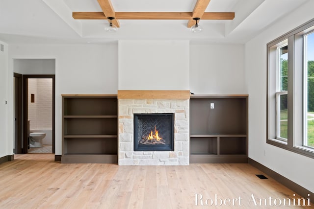6691 Egan Ave SE, Caledonia, MI 49316 - unfurnished living room with coffered ceiling, plenty of natural light, wood finished floors, a stone fireplace, and beam ceiling
