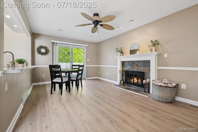 321 Harvard Ave, South Lyon, MI 48178 - dining space with wood finished floors, a ceiling fan, a tile fireplace, and recessed lighting