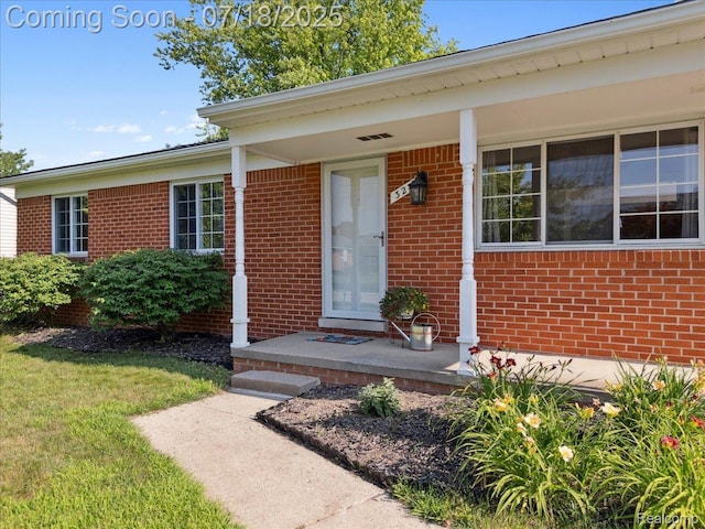 321 Harvard Ave, South Lyon, MI 48178 - doorway to property featuring brick siding