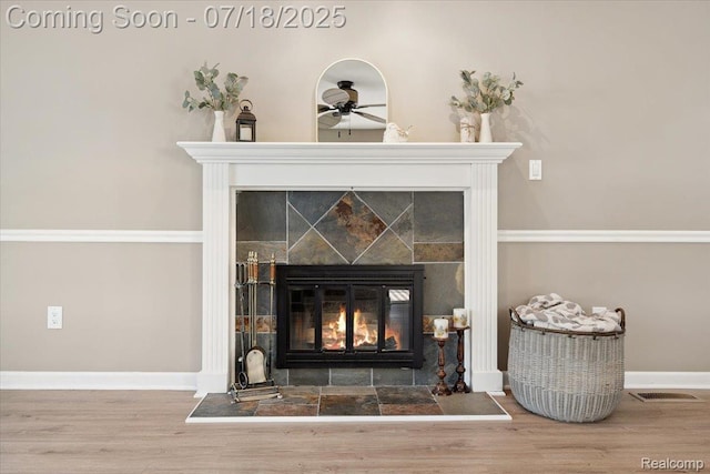 321 Harvard Ave, South Lyon, MI 48178 - detailed view of a fireplace, ceiling fan, and wood finished floors