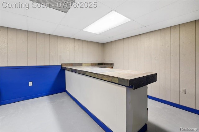 321 Harvard Ave, South Lyon, MI 48178 - bar featuring a paneled ceiling, finished concrete floors, and wooden walls