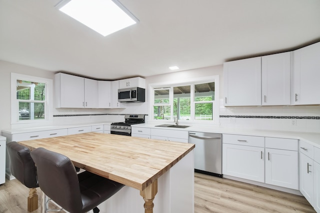 17016 6th St, Wellston, MI 49689 - kitchen featuring stainless steel appliances, light wood finished floors, white cabinetry, and recessed lighting