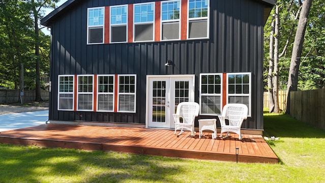 17016 6th St, Wellston, MI 49689 - rear view of house with board and batten siding, a wooden deck, and french doors