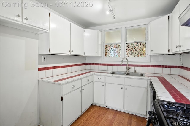 420 Wellsboro St, Walled Lake, MI 48390 - kitchen with tile counters, black gas stove, and white cabinets