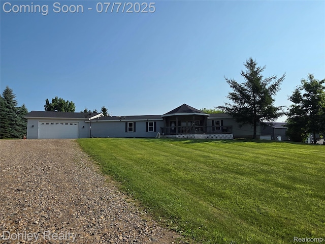 4605 Pleasant St, Clifford, MI 48727 - view of front of house with dirt driveway, a front yard, a garage, and a deck