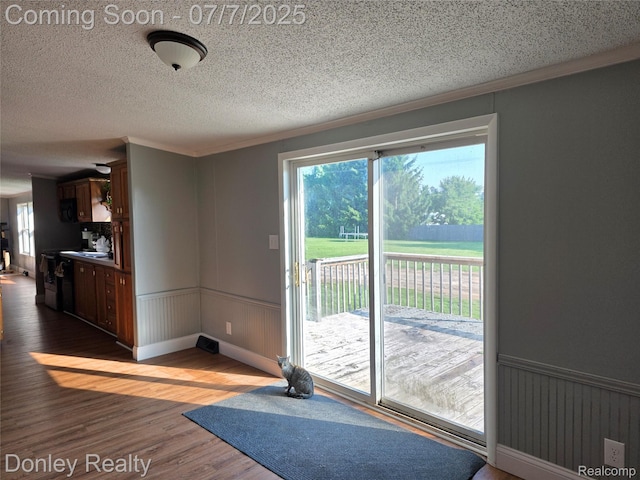 4605 Pleasant St, Clifford, MI 48727 - workout room with healthy amount of natural light, wood finished floors, a textured ceiling, crown molding, and wainscoting