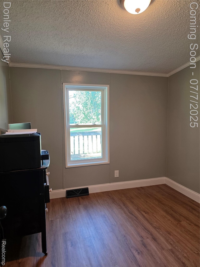 4605 Pleasant St, Clifford, MI 48727 - unfurnished office featuring dark wood-style flooring, a textured ceiling, and crown molding