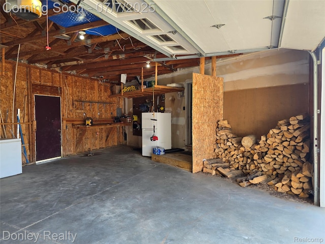 4605 Pleasant St, Clifford, MI 48727 - garage with freestanding refrigerator and a garage door opener