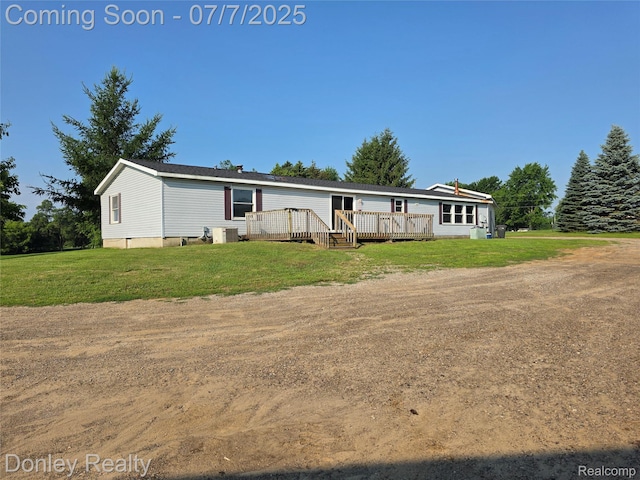 4605 Pleasant St, Clifford, MI 48727 - view of front of house featuring a deck and a front yard