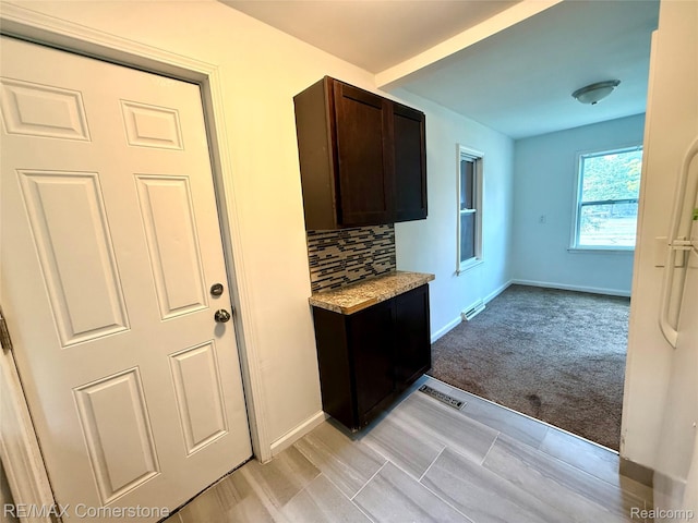35209 Sheridan Ave, Westland, MI 48185 - kitchen featuring dark brown cabinetry, backsplash, and light carpet