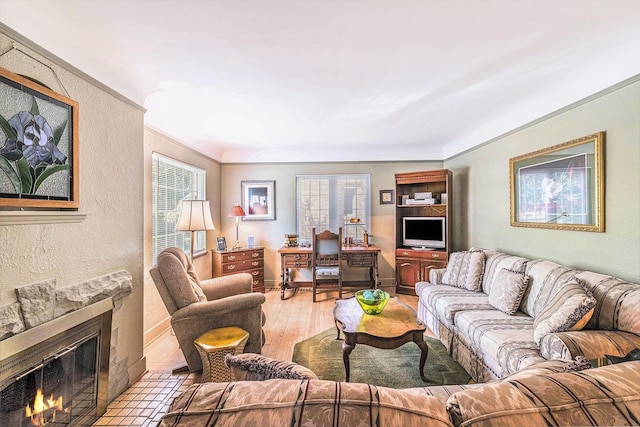 927 Kensington Ave, Flint, MI 48503 - living area with a large fireplace, ornamental molding, light wood-style flooring, and a textured wall