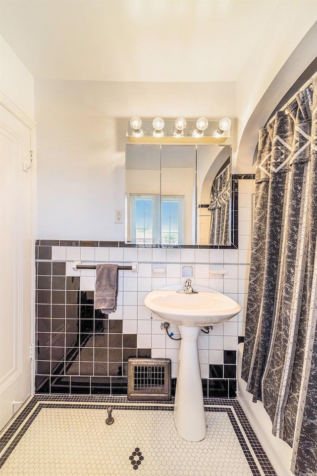 927 Kensington Ave, Flint, MI 48503 - full bathroom featuring tile walls, tile patterned flooring, and wainscoting